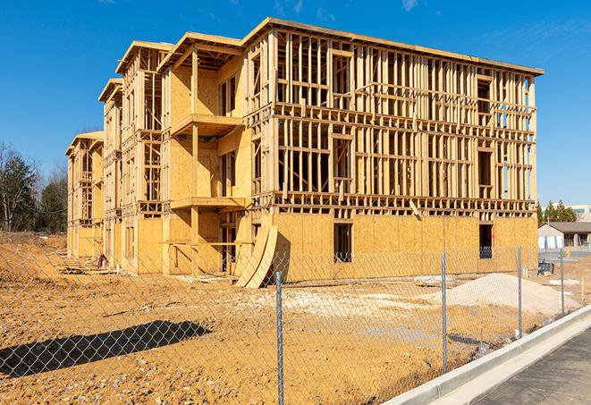 workers protected by temporary barrier fence during building maintenance in Elk Ridge UT